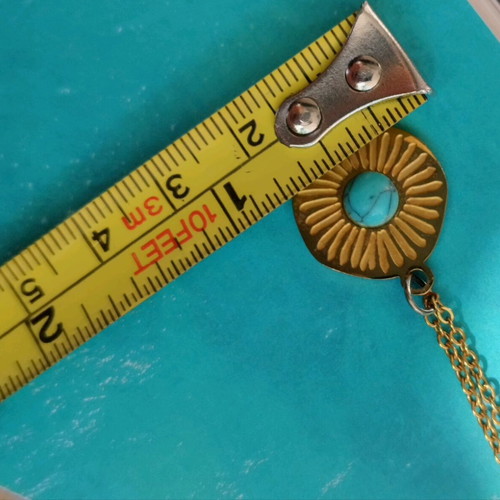 Steel necklace like new with blue mataki stone gold color