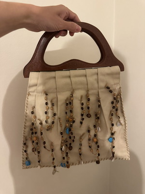 Vintage handbag with wooden handle decorated with stones and shells