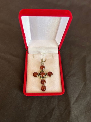Silver cross with brown-red stones used