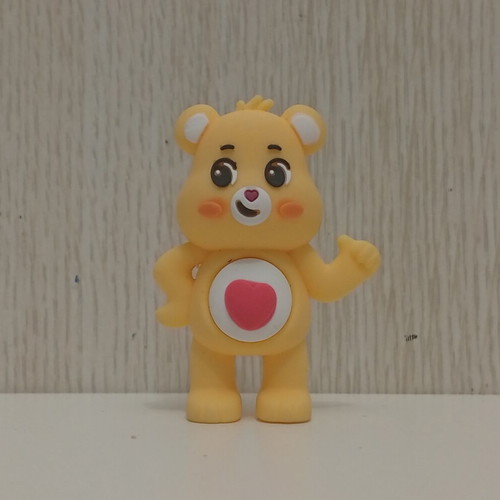 Care Bears Yellow Love-A-Lot Bear figure used with red heart