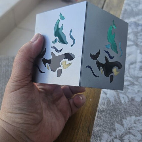 Metal tealight holder with stained glass dolphins