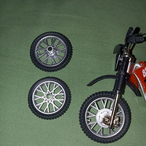 Motocross toy miniature new with extra wheels and nuts