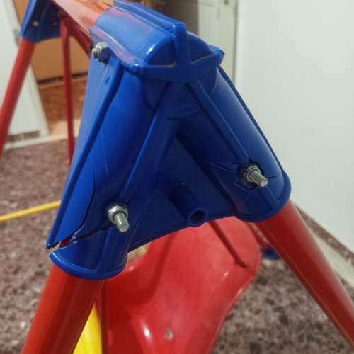 Child swing with metal frame and plastic seat, used with plastic wear