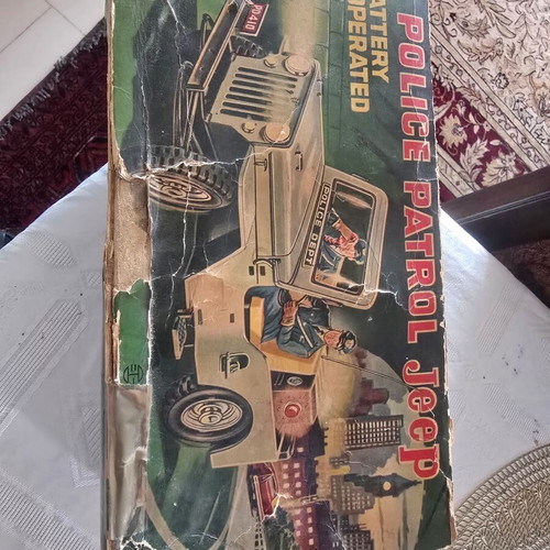 Tin police car from the 1950s like new with officers