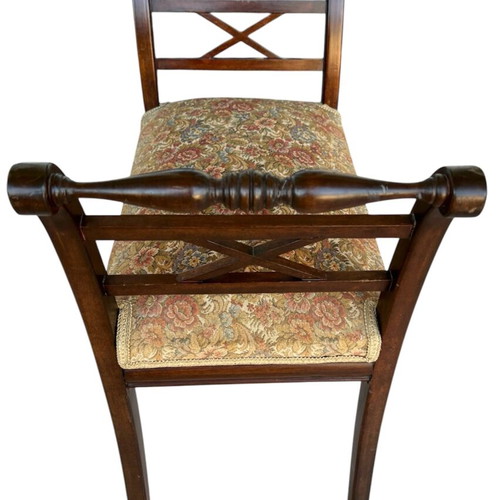 Wooden stool with carved high arms
