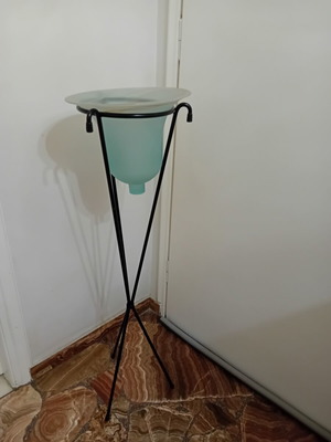 Handmade metal floor plant stand with glass blue-green container, used