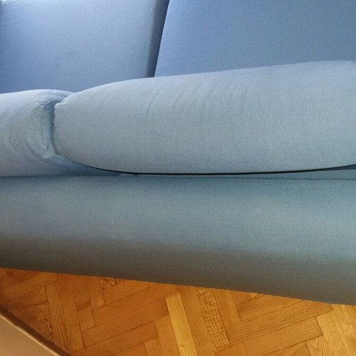 Two-seater sofa used without two back cushions