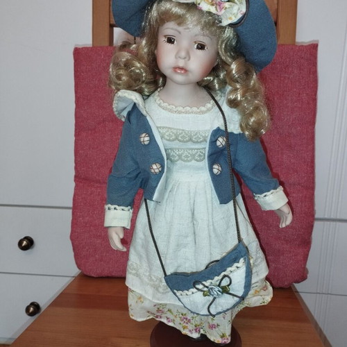 Porcelain doll rare, new with hat and dress