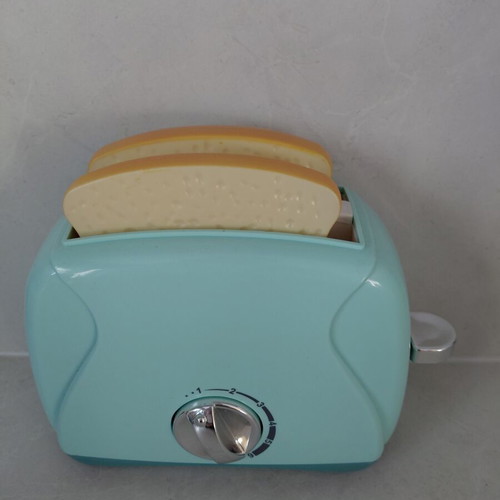 Toy Toaster like new with realistic functions and two fake bread slices