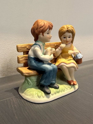 Porcelain decoration with two children on bench like new