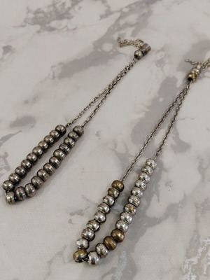 Two metal worry beads used