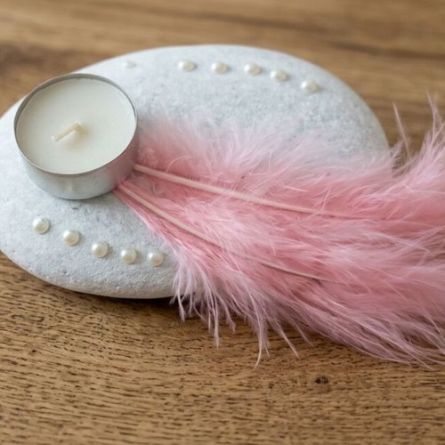 Handmade decorative candle on stone with pink feathers new