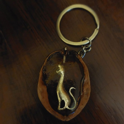 Handmade keychain with natural walnut shell and metal cat