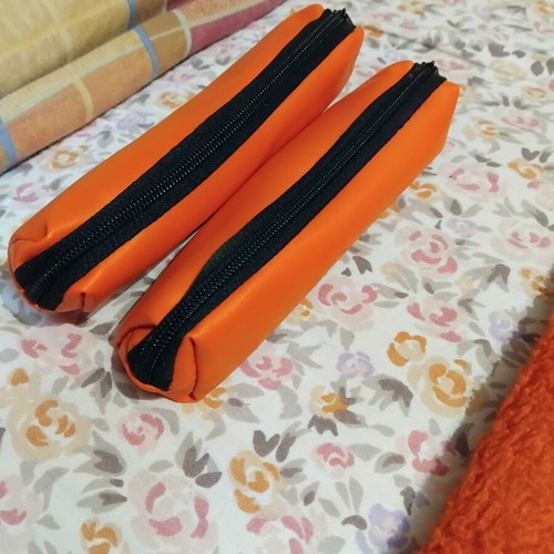 Set of orange pencil cases like new, minimal design