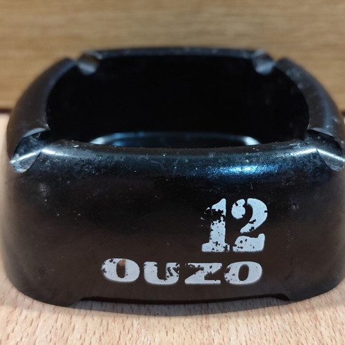 Ouzo 12 square black plastic ashtray used