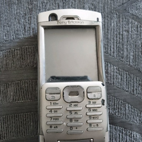 Sony Ericsson P 990i vintage mobile phone used with dock and charger