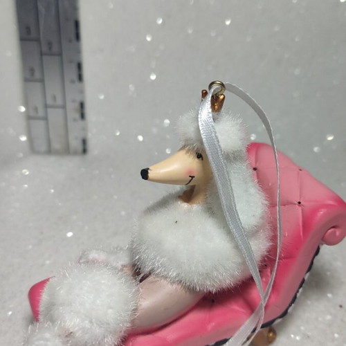 Dog ornament on chaise lounge, hanging decoration