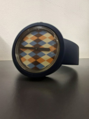O clock watch used with blue silicone strap and Harlequin dial