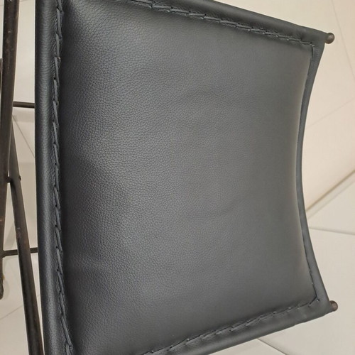 Leather footstool like new, black with cast iron frame