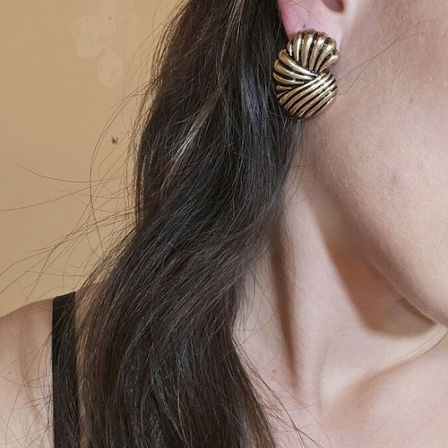 Metal earrings like new with ridges gold-colored