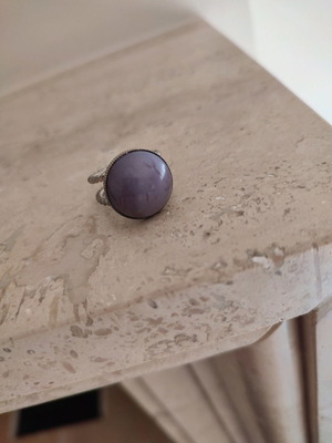 Faux ring with purple stone used, adjustable size