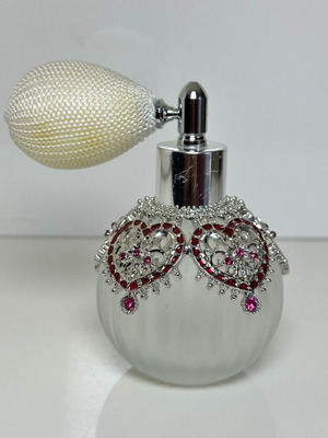 Vintage perfume bottle with pump, decorative hearts and crystals