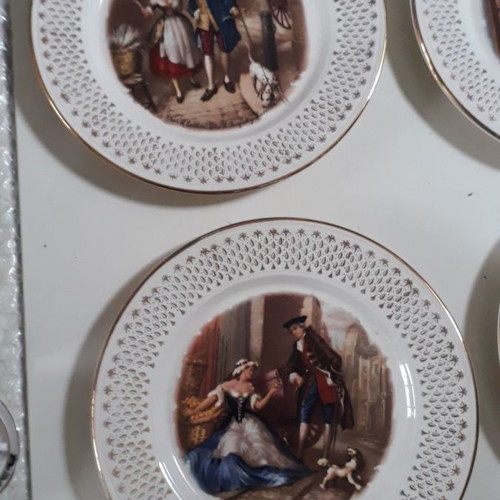 Set of four used French wall plates with gold designs 23cm