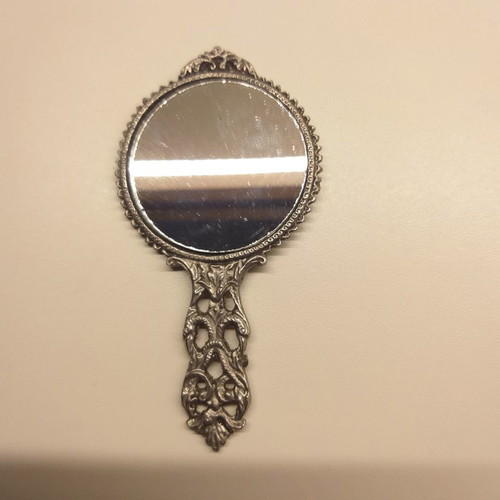 Carved old hand mirror used