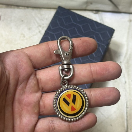 Volkswagen vintage metal keychain with classic logo, used