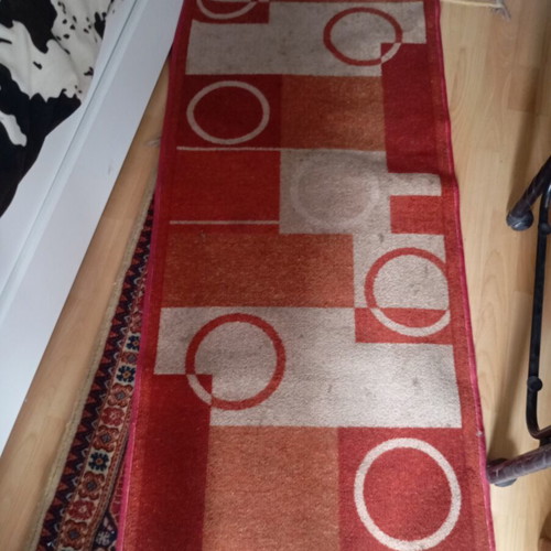 Vintage carpet runner used with geometric motifs in warm colors