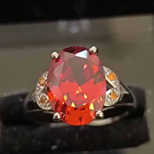 Ring with Large Red Ruby-Colored Stone and Decorative Stones