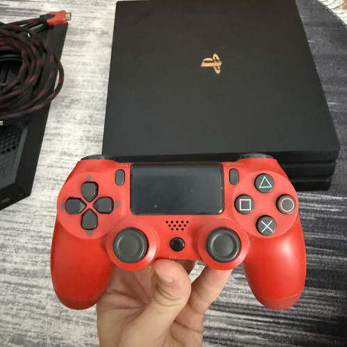 Sony PlayStation 4 Pro 1TB console used with controllers and charging dock