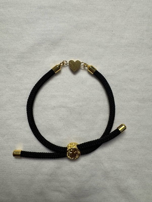 Handmade minimal bracelet with black cord, gold-plated details and heart
