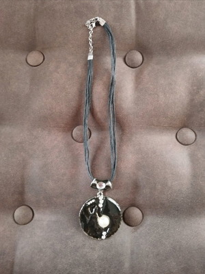 Pendant used with black and white cord