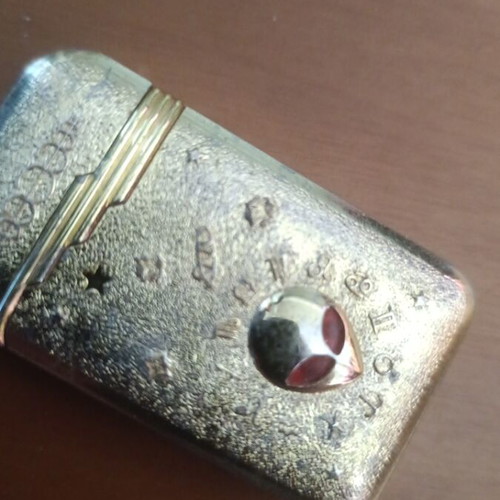 Collectible metal lighter used with zodiac symbols and alien motif