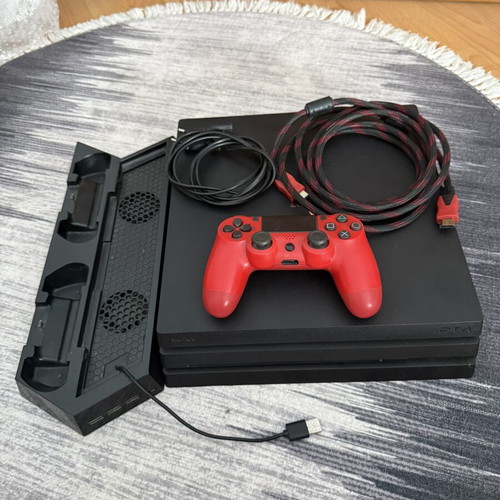 Sony PlayStation 4 Pro 1TB console used with controllers and charging dock