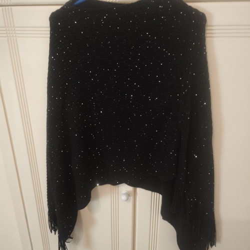 Black knitted poncho size S with subtle shiny sequins and fringes