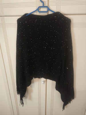 Black knitted poncho size S with subtle shiny sequins and fringes