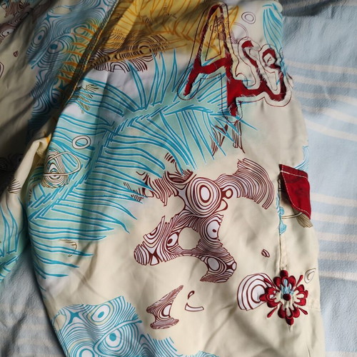 Aggressive men's swim shorts size L like new, multicolor tribal print