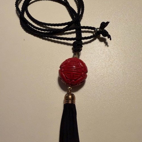 Long pendant like new with red carved bead and black fabric cord