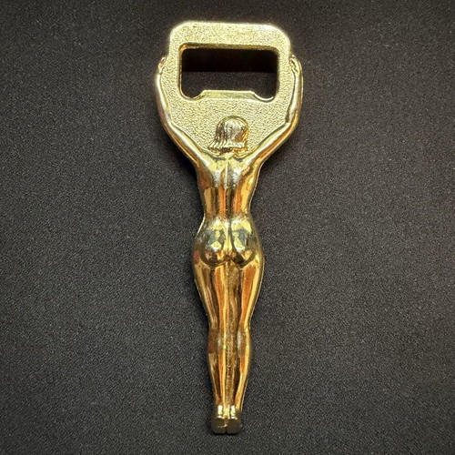 Vintage metal bottle opener with golden female figure