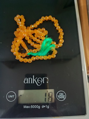 Collectible komboloi with 99 beads, like new, yellow-orange with green tassel