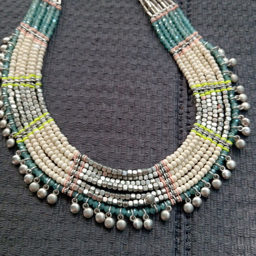 Accessorize multistrand necklace with plastic and glass beads