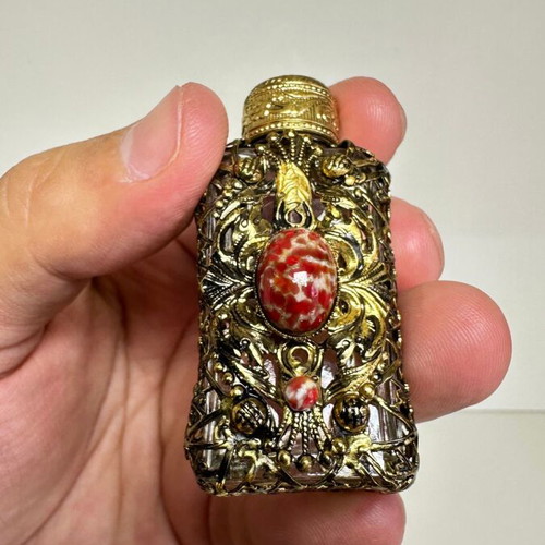 Vintage perfume flacon with filigree metalwork and red cabochon