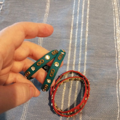 Leather bracelets used, red and green with charms
