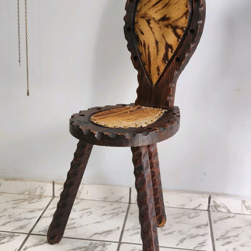 Spanish rustic chair used with three legs and animal leather from the 1960s