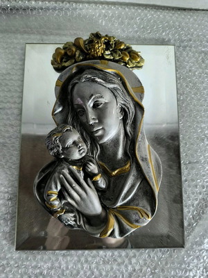 Embossed depiction on mirror of Virgin Mary used