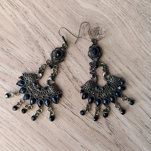 Long metal earrings used, black and gold
