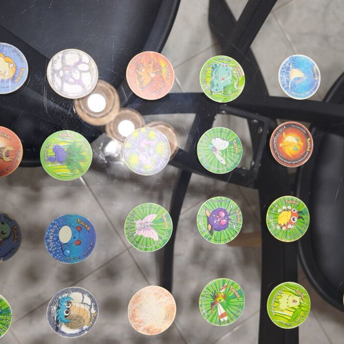 Pokemon Tazos used with visible wear