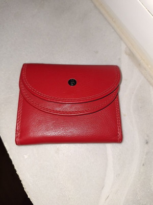 Small red wallet with coin and bill compartments